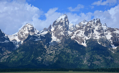 panorama of the spectacular peaks of the grand teton range on sunny summer day in grand teton national park, wyoming