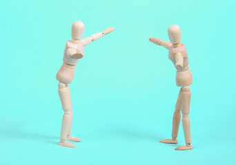 Two emotional wooden puppets on a blue background