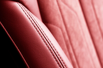 Modern luxury car red leather with alcantara interior. Part of red leather car seat details with...