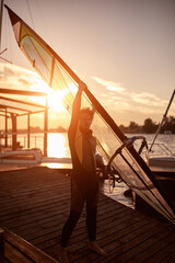 Fototapeta premium Windsurfer surfing on a windy day at the river.