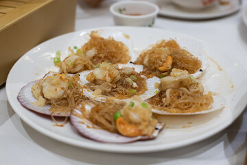 Steamed scallops with vermicelli on the dining table
