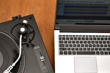 Computer laptop and turntable for digitizing vinyl records. Playing and recording vinyl records on...
