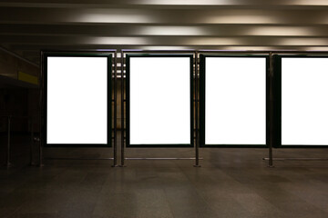 Front view of four empty white banners background at the metro station. Mock up. Blank advertising billboards in the subway, copy space for text.