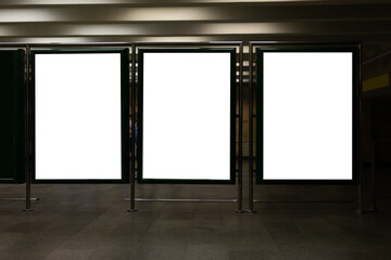 Front view of three empty white billboard screens at the metro station. Mock up. Blank advertising...
