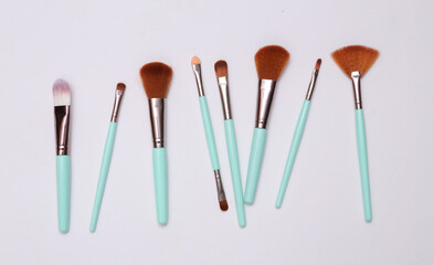 Set of makeup brushes on white background. Top view