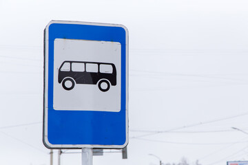 Close up road sign bus stop on gray sky background. City life and road traffic concept. Elements of...