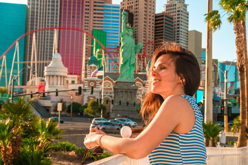 A young woman walks through the streets of the city with hotels in Las Vegas. Las Vegas, USA - 18 Apr 2021