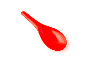 Red color of plastic spatula isolated on white background.