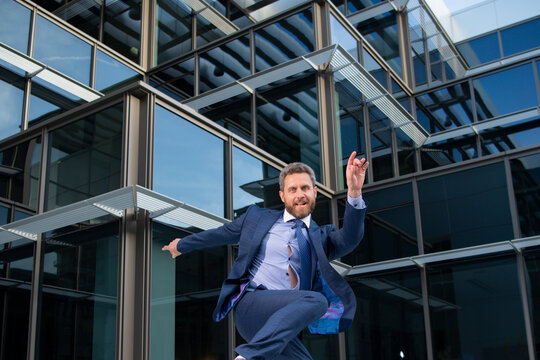 Business excitement. Funny businessman jumping for joy celebrating a successful.