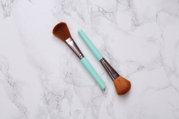 Makeup brushes on marble surface. Beauty products