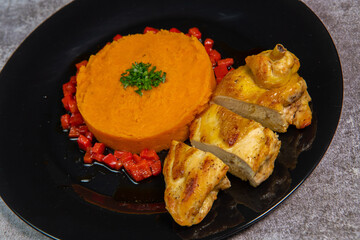 Chicken supreme recipe, gently cooked with 5 spices, sweet potato mousseline, peppers cut in half. High quality photo