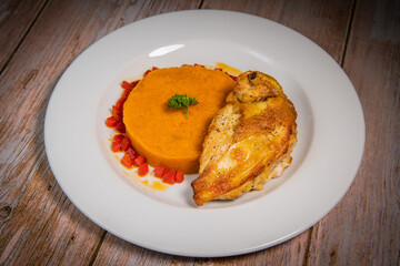 Chicken supreme recipe, gently cooked with 5 spices, sweet potato mousseline, peppers cut in half. High quality photo