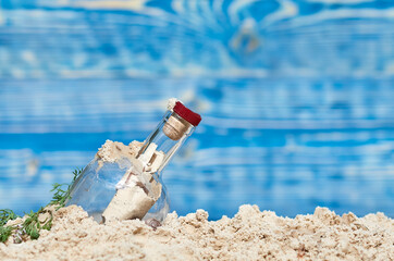 the bottle with the letter is buried in the sand