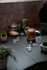 Close-up of iced coffee served on black table at cafe​