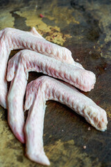 Close-up of raw duck wings on cutting board
