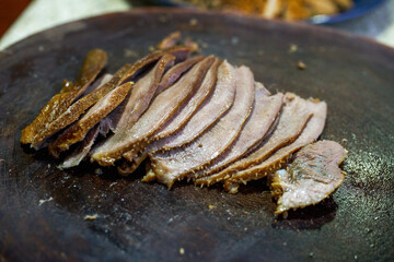 A chef is cutting stewed lo-mei dishes, stewed beef tongue