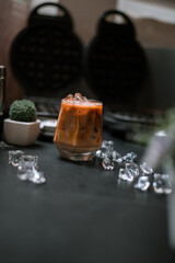 Close-up of iced coffee served on black table at cafe​