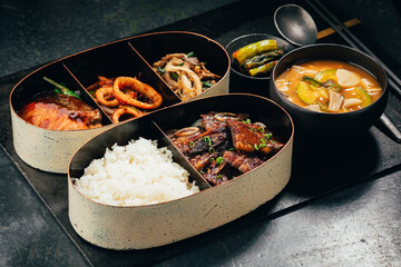 Seafood bento with rice , tofu soup and kimchi