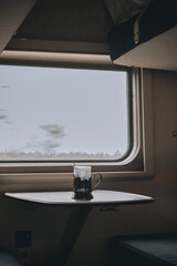 a lone mug rides a train on an interesting adventure