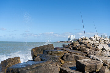 Beautiful view of the water splashing on the rocks at Mar del Plata, Argentina