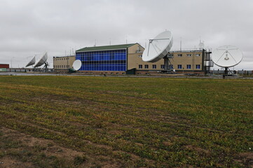 Fototapeta na wymiar Almaty, Kazakhstan - 11.20.2015 : Parabolic industrial antennas and the territory of the KAZSAT satellite control center