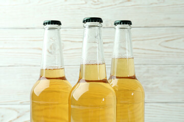 Bottles of beer on white wooden background