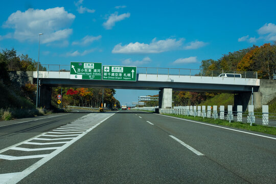 Hokkaido Road Trip : The rural road on Hokkaido expressway in Autumn season, the way leading through New Chitose airport and Sapporo city.
