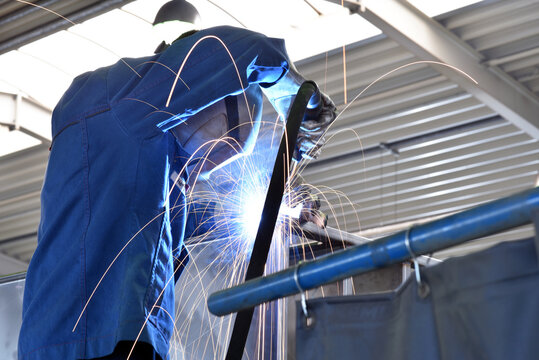 welder at work in a steel construction company - working and protective clothing