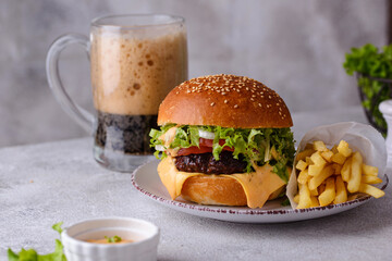 Cheeseburger with beef cutlet and vegetables