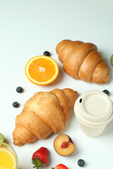 Concept of tasty breakfast with croissants on white background