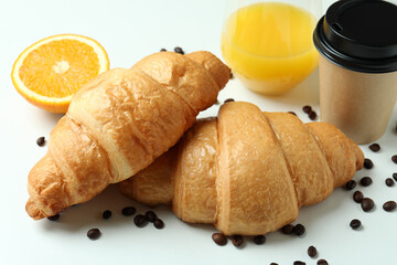 Concept of tasty breakfast with croissants on white background