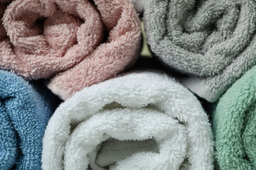 Fototapeta na wymiar Clean rolled towels on whole background, close up