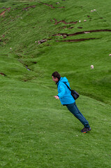 Man fights against the strong winds - finding a balance  - lean on the wind