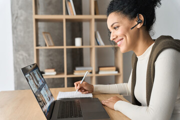 African American mixed race adult student wearing headset having virtual meeting online call...