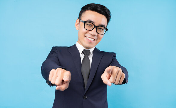 Asian Buisnessman Wearing Suit Pointing On Blue Background