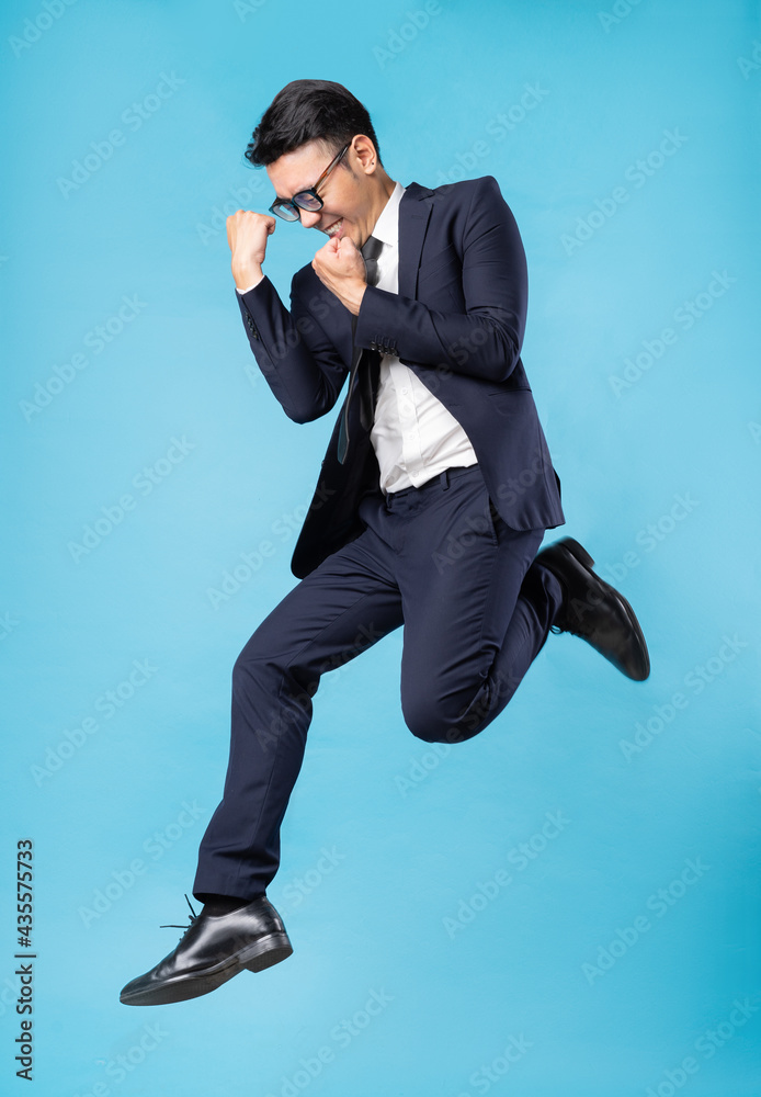 Sticker asian buisnessman wearing suit and jump up on blue background