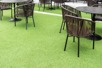 outdoor table set. Placed on an artificial green grass, table set for dining decorating with...