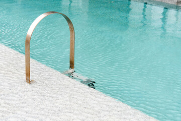 Swimming pool with stair at hotel.