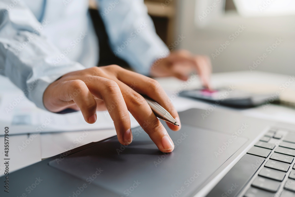 Aufkleber accountant use calculator and computer with holding pen on desk in office. finance and accounting co