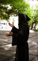 Monk in a black robe near the monastery