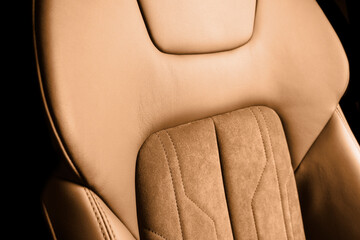 Modern luxury car brown leather with alcantara interior. Part of orange leather car seat details with white stitching. Interior of prestige car. Perforated leather seats isolated. Perforated leather. - obrazy, fototapety, plakaty