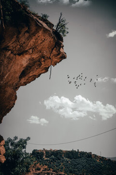 A snapshot of the beauty of nature in Iraqi Kurdistan, the edge of a mountain that is about to fall, and behind it the city of Amidi and birds in the sky and clouds