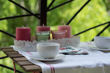 table covered with a tablecloth with colorful candles