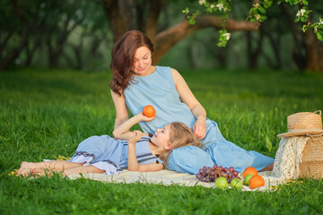 mother and child having fun in the park. Mother and little daughter playing together in a park. Happy family concept.