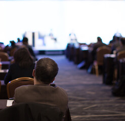 Business People Meeting and Working while Business Executive Lead Presenter Speaks to Group of Successful Technology Entrepreneurs. Consultant Advisor. Growth Training Lecture. Defocused Blurred
