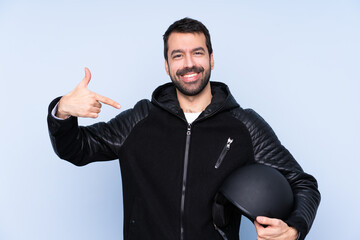 Man with a motorcycle helmet over isolated background proud and self-satisfied