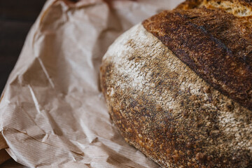 Texture surface of baked bread crust on craft package. Beautiful crispy bread close-up. Selective...