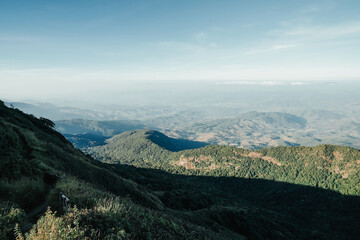 Obraz premium beautiful blue sky high peak mountains green forest guiding for backpacker camping backpacking hiking idea long weekend at Kew Mae Pan Nature Trail Waterfall Doi Inthanon, Chiang Mai, Thailand.