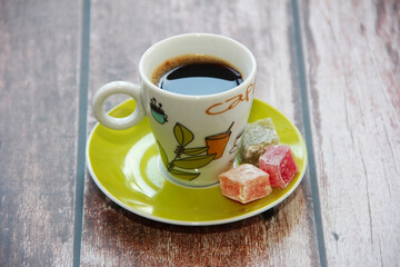 black turkish coffee in a cup and sweet oriental lukum