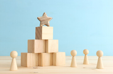 business concept image of people figures over wooden blocks and table, human resources and management concept